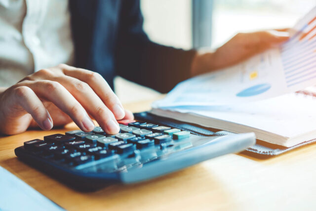Canva-Business-man-Accounting-Calculating-Cost-Economic-Financial-data-analyzing-counting